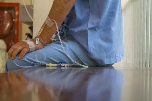 A patient in the hospital with saline intravenous, in Asian elderly man hand