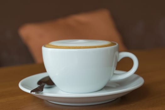 Coffee in white cup on wood table