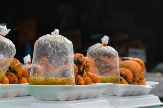 Grilled shrimp in foam box at Thai market