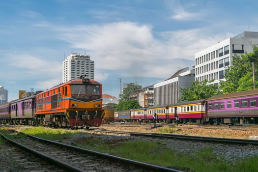 Railway train run on the railroad tracks. Many people in Thailand popular travel by train because it is cheaper.