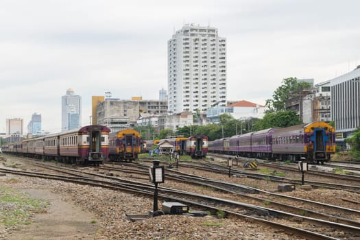 Railway train run on the railroad tracks. Many people in Thailand popular travel by train because it is cheaper.