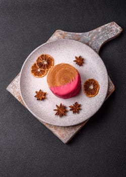 Round sweet New York roll croissant with raspberry cream filling on a dark concrete background