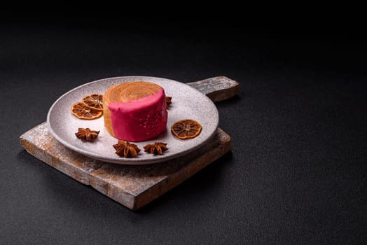 Round sweet New York roll croissant with raspberry cream filling on a dark concrete background