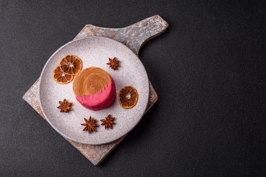 Round sweet New York roll croissant with raspberry cream filling on a dark concrete background