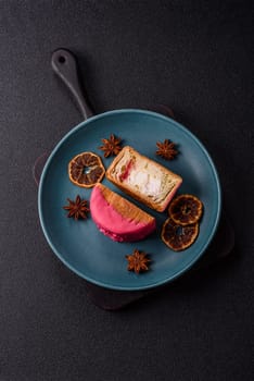 Round sweet New York roll croissant with raspberry cream filling on a dark concrete background