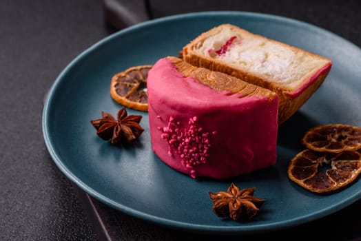 Round sweet New York roll croissant with raspberry cream filling on a dark concrete background