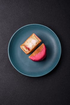Round sweet New York roll croissant with raspberry cream filling on a dark concrete background