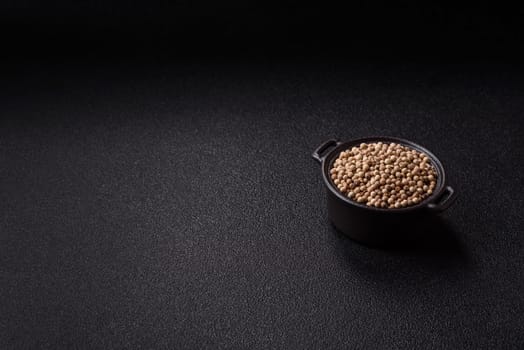 White allspice in a ceramic bowl on a dark concrete background