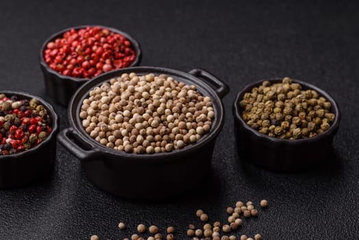 White allspice in a ceramic bowl on a dark concrete background