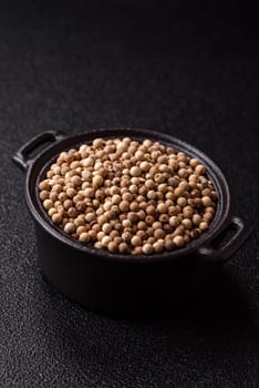 White allspice in a ceramic bowl on a dark concrete background