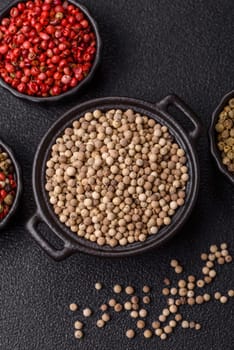 White allspice in a ceramic bowl on a dark concrete background
