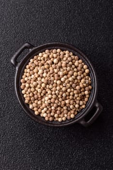 White allspice in a ceramic bowl on a dark concrete background