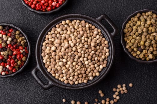 White allspice in a ceramic bowl on a dark concrete background