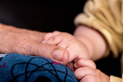 This image captures a close-up of a human hand resting on a soft surface, showcasing the texture of the skin and the contrast between age and comfort.