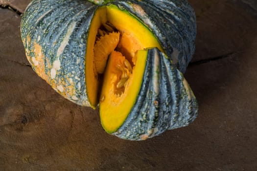 Pumpkin is a fresh vegetable have a green and yellow color on a wooden table