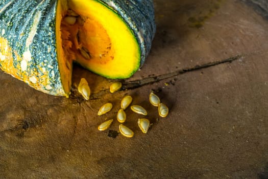 Pumpkin is a fresh vegetable have a green and yellow color on a wooden table