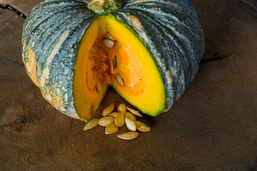 Pumpkin is a fresh vegetable have a green and yellow color on a wooden table