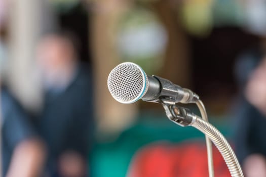 Microphone in seminar event or meeting room use mic for sound amplify when talk or communicate on stage defocus on meeting room background