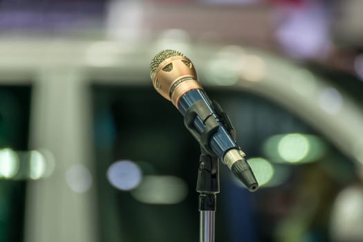 Microphone in seminar event or meeting room use mic for sound amplify when talk or communicate on stage defocus on meeting room background