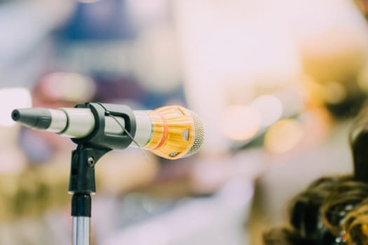 Microphone in seminar event or meeting room use mic for sound amplify when talk or communicate on stage defocus on meeting room background
