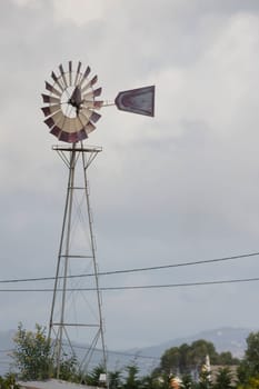 Weather station with anemometer and blue sky in the background, telephoto
