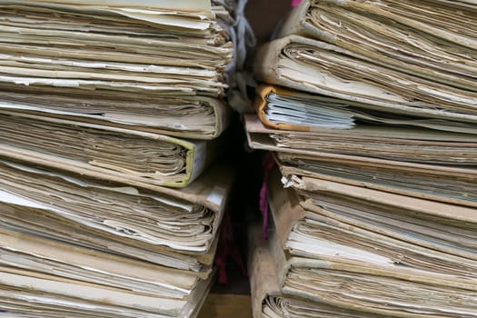 Old files in old folder stacking up in a messy order.