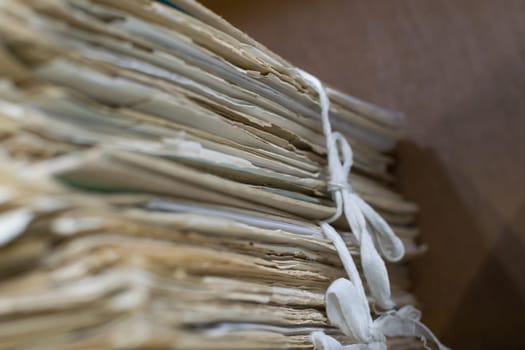 Old files in old folder stacking up in a messy order.