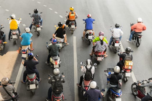 Motorcycle wait to go at intersection with traffic light on a road.