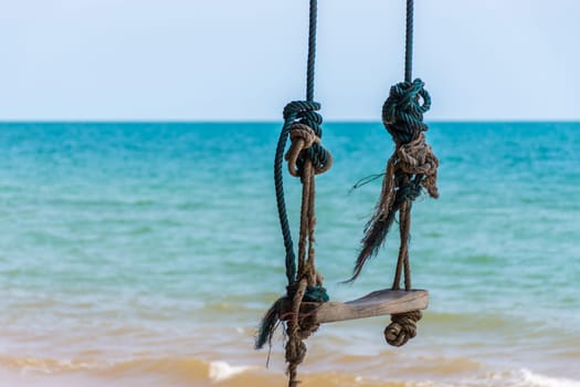 Landscape of travel place with nature at a beach and tropical sea with blue sky and have a outdoor swing use for relax in happy vacation