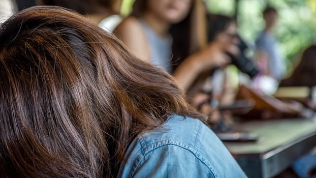 Asia woman take a photo by her camera at restaurant or cafe when travel with her best friends