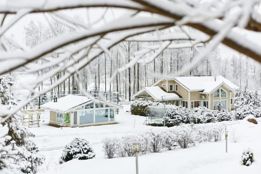 beautiful country house in a snowy pine forest, night lighting, winter fairy tale. High quality photo