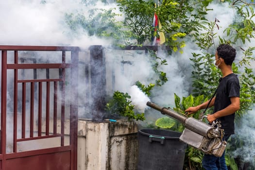 People fogging DDT spray kill mosquito for control Malaria, Encephalitis, Dengue and Zika in village at Bangkok Thailand.