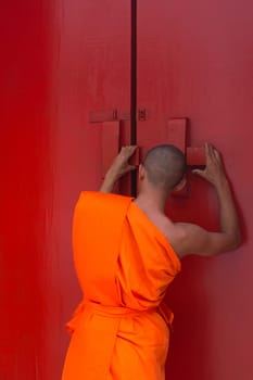 Thai monk and buddhist temple gate is a wooden door red color vintage style