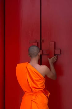 Thai monk and buddhist temple gate is a wooden door red color vintage style