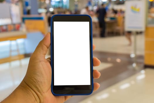Person hand holding smartphone or mobile phone with white screen using in supermarket for shopping