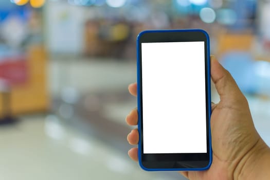 Person hand holding smartphone or mobile phone with white screen using in supermarket for shopping