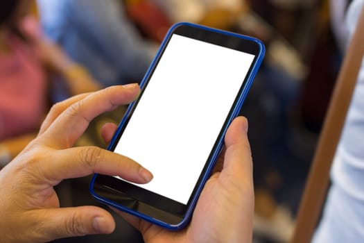 Person hand holding smartphone or mobile phone with white screen using in skytrain for checking