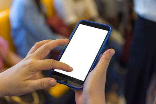 Person hand holding smartphone or mobile phone with white screen using in skytrain for checking