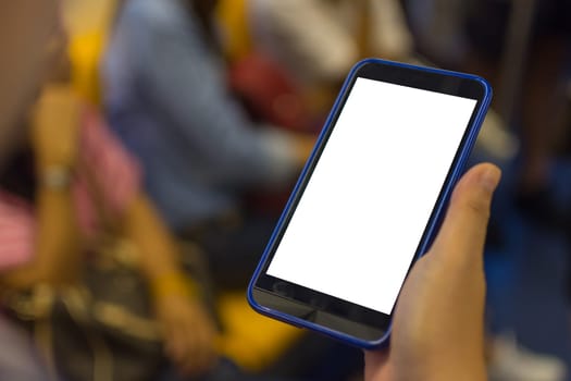 Person hand holding smartphone or mobile phone with white screen using in skytrain for checking