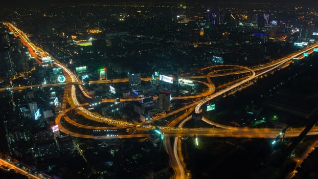 Cityscape, Expressway with light of car on road and Bangkok city with building and transportation in nighttime from Skyscraper by long exposure photography