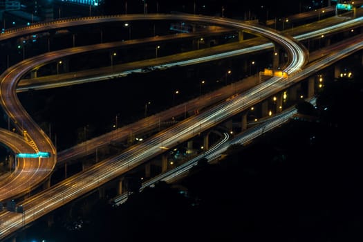 Cityscape, Expressway with light of car on road and Bangkok city with building and transportation in nighttime from Skyscraper by long exposure photography