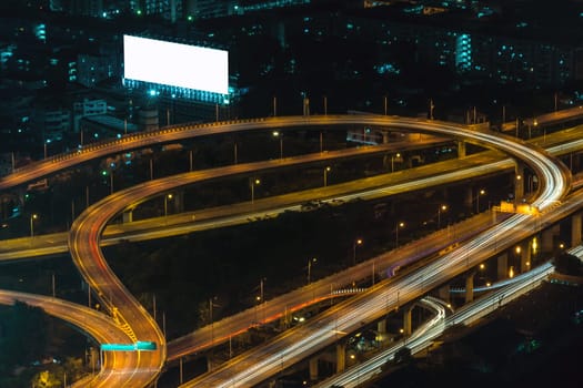 Cityscape, Expressway with light of car on road and Bangkok city with building and transportation in nighttime from Skyscraper by long exposure photography