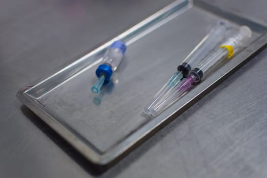 Syringe with needle on a steel tray for a medical vaccine in a hospital