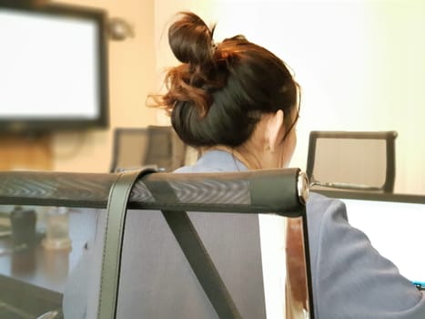 Asian business woman discussion with team and work by laptop or computer notebook in meeting room at her corporate office
