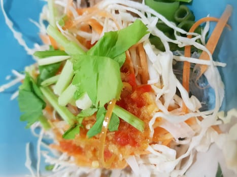 Spicy tom yum noodle with pork for sale at Thai street food market or restaurant in Thailand