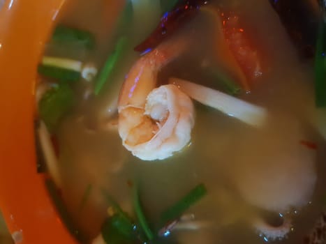 Prawn seafood spicy soup (Tom Yum Goong) is a famous Thai food have a spicy in Thai street food market at Bangkok Thailand