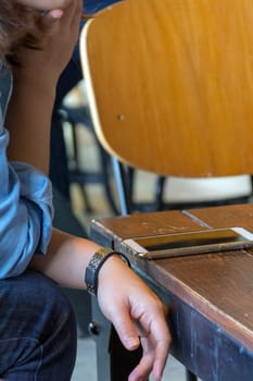 Mobile phone and women on wood table in coffee shop or restaurant