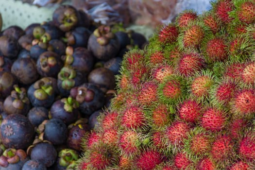 Thai exotic fruits (Rambutan and Mangosteen) in market. Like the charming people, exotic fruit greets you on almost every corner in Thailand.