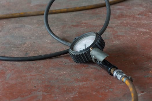 Tire car air pressure with gauge in garage