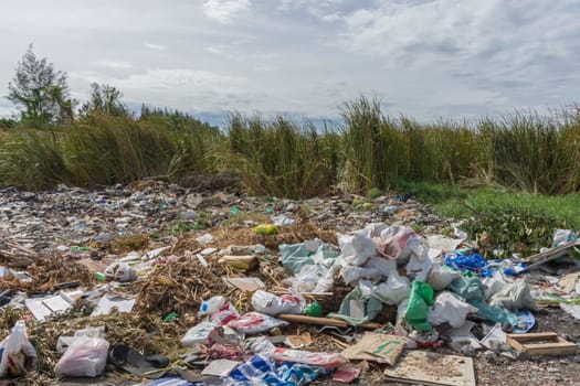 Garbage and junk dump to the landfill in field it illegal, hazardous and dangerous for environment